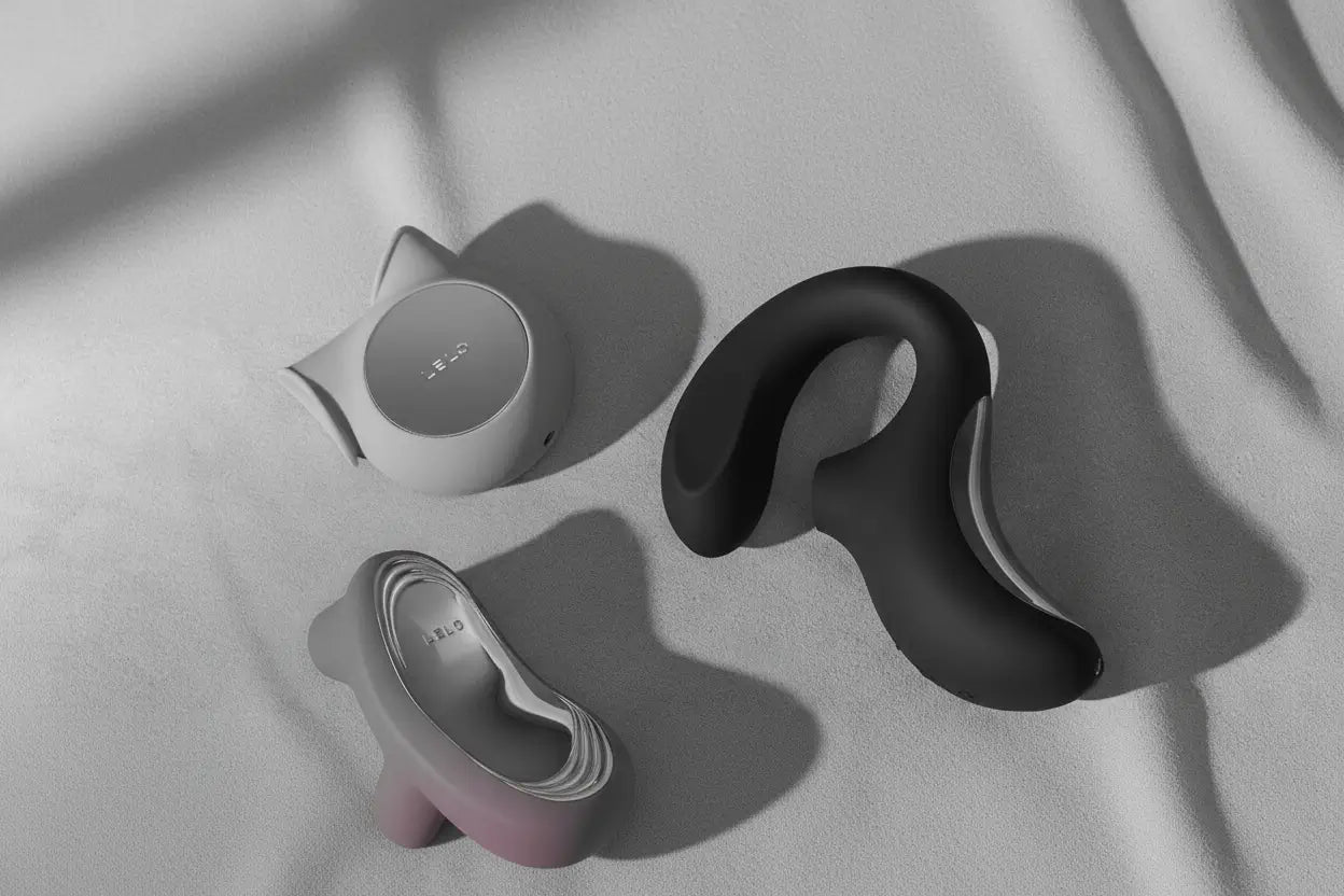 Three adult toys on a light gray surface with soft shadows.